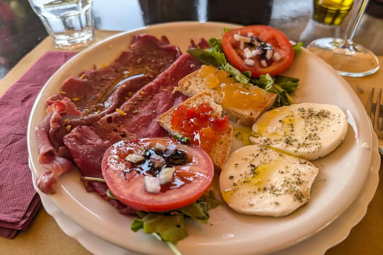 Platter of fresh vegetables and cured meats served during a wine tasting near Lucca Italy