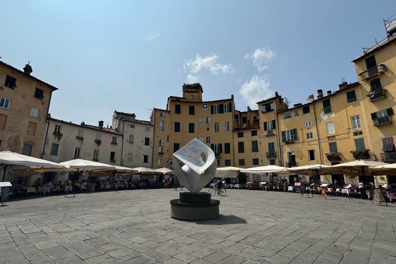 The ancient Roman amphitheater in Lucca Italy, surrounded by charming yellow buildings