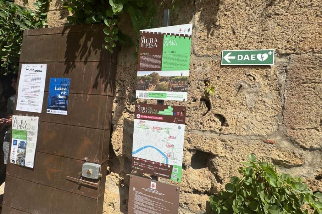 Sign showing ticket prices for the elevated wall walk near the Leaning Tower of Pisa