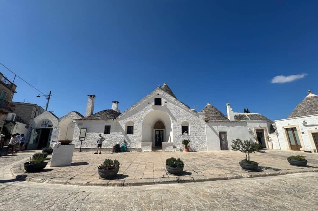 Exterior view of the Trulli museum in Alberobello showing traditional white cone-shaped houses and historic architecture