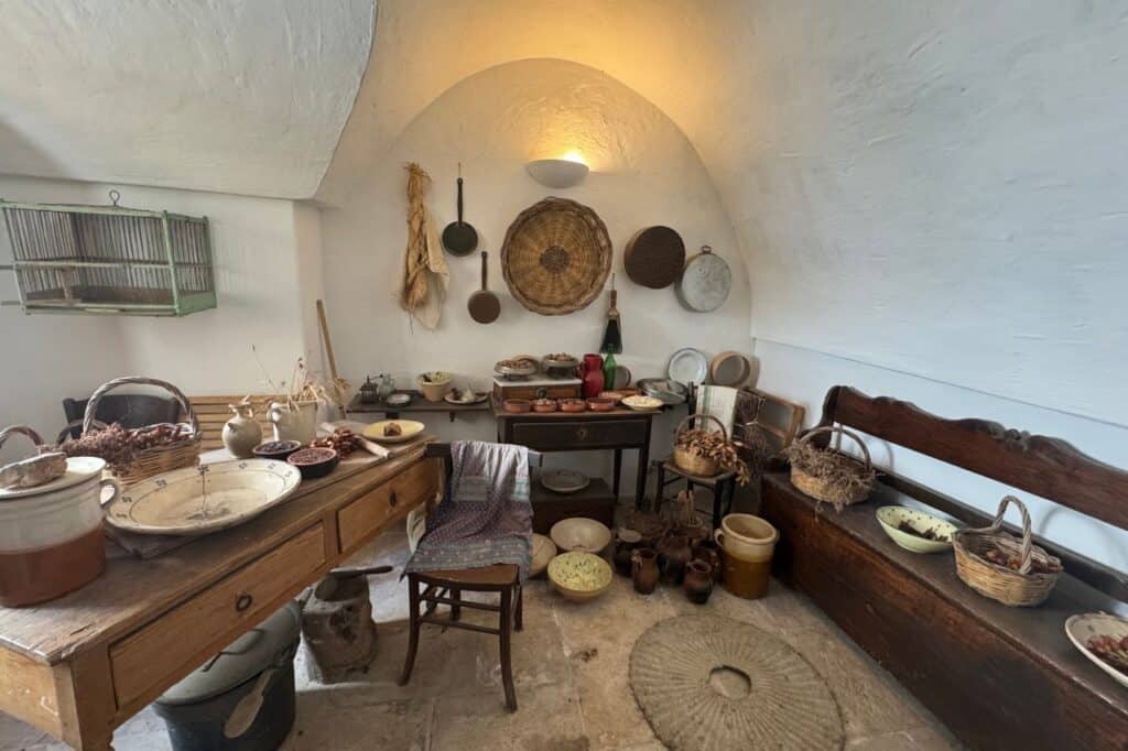 Inside view of the Alberobello Trulli museum showing traditional furnishings and historical displays