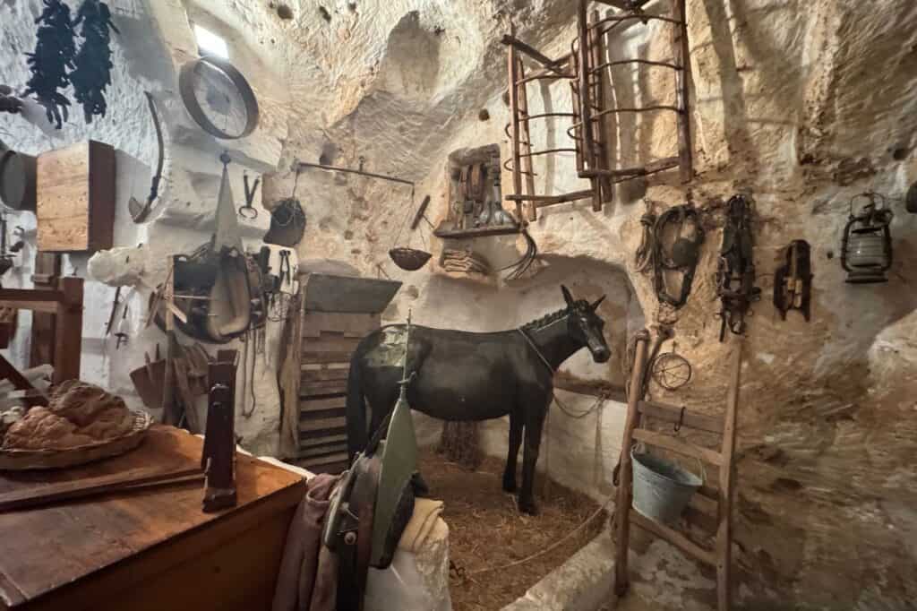 Interior of Matera cave home with original antique furniture and traditional stone walls