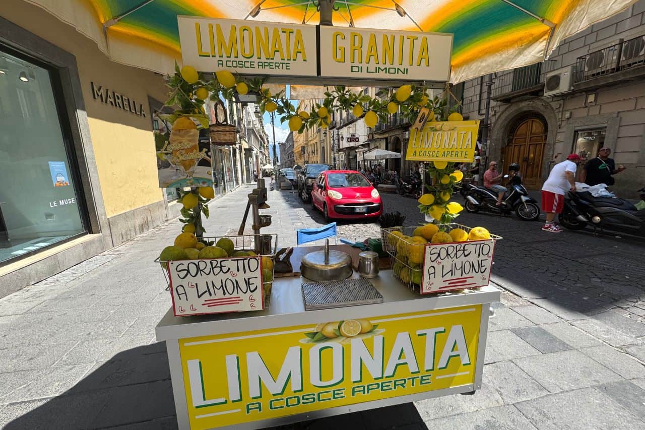 Street vendor preparing limonata a cosce aperte, the fizzy lemon drink in Naples