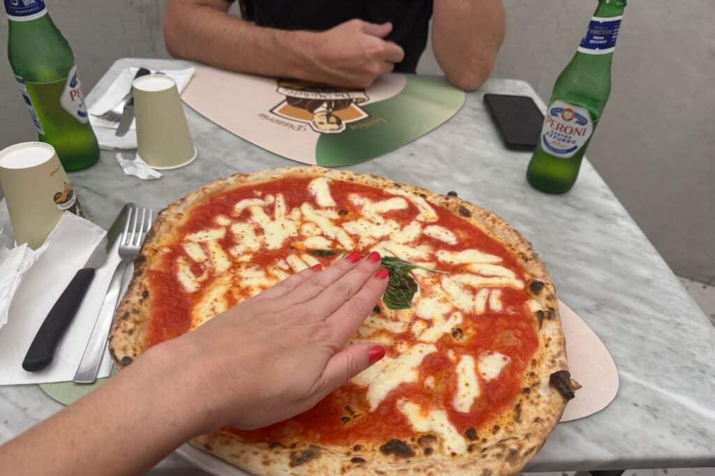Neapolitan Margherita pizza with tomato, mozzarella, and basil served on a plate in Naples Italy