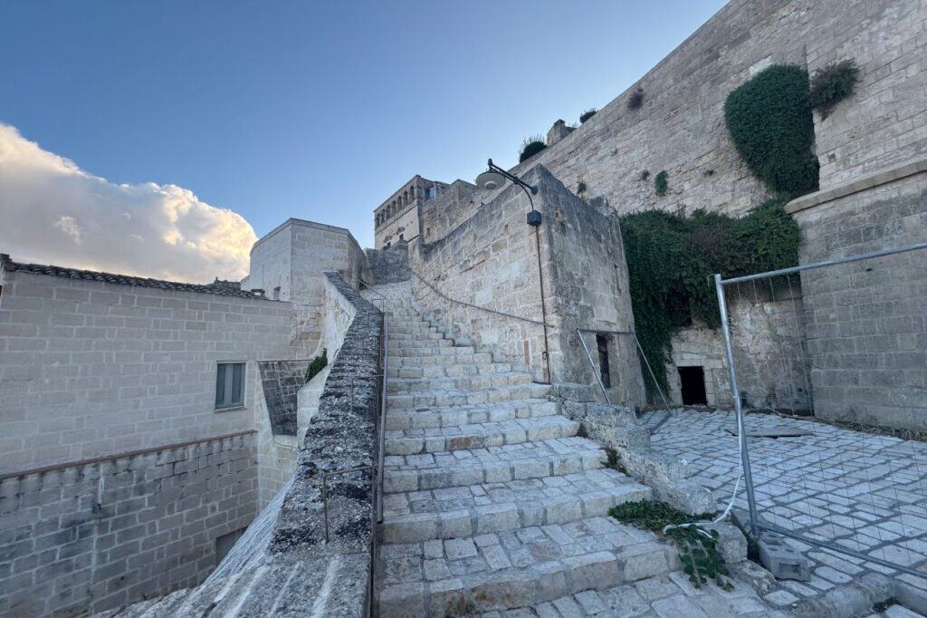 Narrow stone staircase winding through Matera’s ancient cave dwellings and historic homes