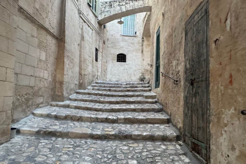 Wide stone staircase going under an underpass in Matera