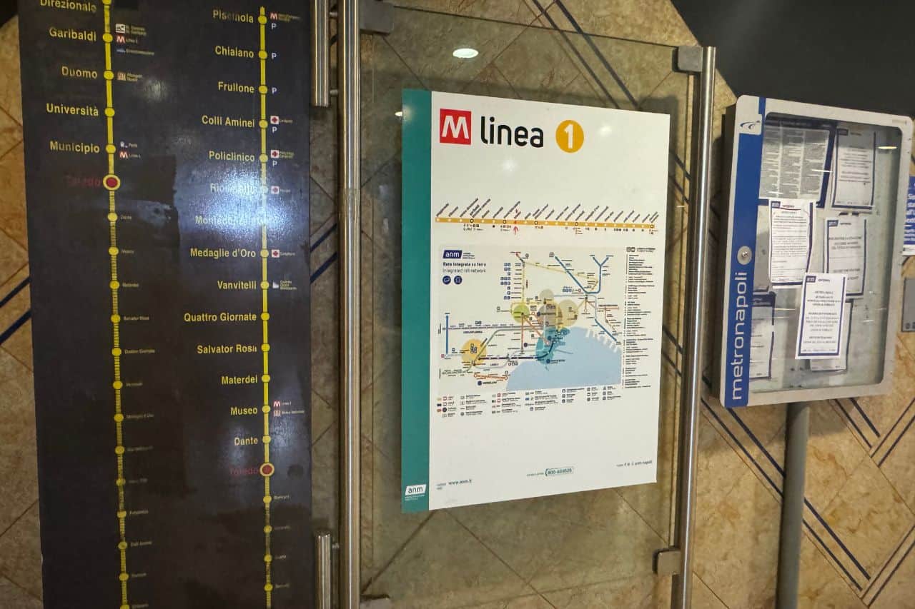 Metro line sign and map showing stops and routes for Naples public transportation system, Italy