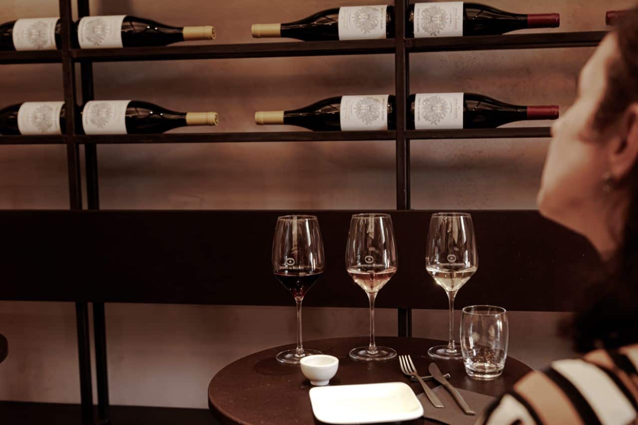 Guests enjoying an Etna wine tasting with red, rosé, and white wines at Tenute dei Ciclopi in Catania.